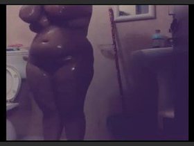 South Asian aunt indulges in risque behavior while taking a bath, flaunting her curvy physique