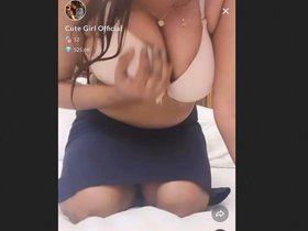 The adorable Tango girl flaunts her stunning cleavage in this official video