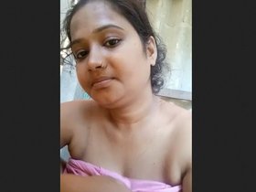 Attractive Indian woman displays her large breasts