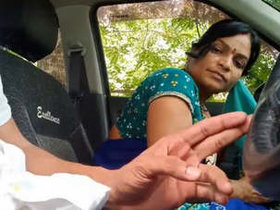 Indian housewife gives oral pleasure to her lover in a car with Hindi soundtrack