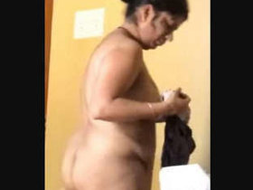 Indian aunt undresses in front of camera