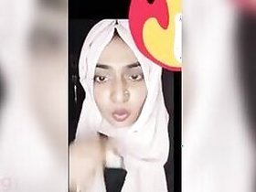 Girl Hijabi Desi plays with her plump pussy on camera