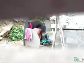 A neighbor on a hidden camera filmed his aunt taking a bath outdoors naked